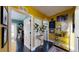 Bright, yellow hallway featuring artwork, a mirror, and doorways to other rooms at 1011 W Charter St, Tampa, FL 33602