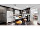 Modern kitchen with dark cabinetry, granite countertops, and stainless steel appliances at 1011 W Charter St, Tampa, FL 33602