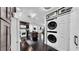 Open-concept kitchen view with a center island, stainless steel appliances, and a stackable washer/dryer at 1011 W Charter St, Tampa, FL 33602