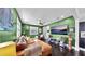 Spacious living room featuring a large sectional, ceiling fan, and modern decor at 1011 W Charter St, Tampa, FL 33602
