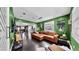 Bright living room with hardwood floors, leather sectional, and large windows at 1011 W Charter St, Tampa, FL 33602