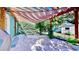 Covered patio featuring pavers, a hammock, and a quaint outdoor seating area with garden views at 1011 W Charter St, Tampa, FL 33602