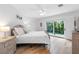 Bedroom featuring wood floors, ceiling fan, closet, with sliding glass door access to the outdoors at 10351 Longwood Dr, Seminole, FL 33777