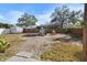 Large backyard featuring a play house, mature trees, and a wood fence at 1101 Jackmar Rd, Dunedin, FL 34698