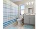 Bathroom featuring shower-tub combination with a striped shower curtain and wood look floors at 11054 Liberto Rd, Weeki Wachee, FL 34614