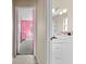 Bright bathroom features a modern white vanity and a glimpse into the pink-themed bedroom at 11054 Liberto Rd, Weeki Wachee, FL 34614