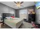 Bedroom featuring a bed, dresser, window, and grey accent wall at 11054 Liberto Rd, Weeki Wachee, FL 34614