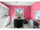 Bright pink bedroom with a large window, filled with light and showcasing a functional workspace at 11054 Liberto Rd, Weeki Wachee, FL 34614