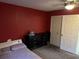 Bedroom featuring a bed, dresser, closet, and red accent wall at 11054 Liberto Rd, Weeki Wachee, FL 34614