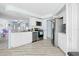 Bright kitchen featuring white cabinets, stainless steel appliances, and modern lighting at 11054 Liberto Rd, Weeki Wachee, FL 34614