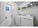 Functional laundry room with appliances and storage shelves, simplifying chores at 11054 Liberto Rd, Weeki Wachee, FL 34614