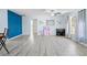 Bright living room with ample space, blue accent wall, and large window with natural light at 11054 Liberto Rd, Weeki Wachee, FL 34614