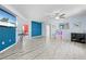 Open living room featuring modern floors and light blue walls leading to other rooms at 11054 Liberto Rd, Weeki Wachee, FL 34614
