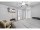 Inviting bedroom featuring a mounted TV, recliner chair, ceiling fan, and closet at 11054 Liberto Rd, Weeki Wachee, FL 34614