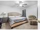 Comfortable main bedroom with a ceiling fan, recliner, and ample natural light at 11054 Liberto Rd, Weeki Wachee, FL 34614