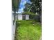 Overgrown backyard featuring a shed and a wooden fence at 12139 Buffington Ln, Riverview, FL 33579