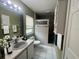 Well-lit bathroom with a vanity, toilet, shower, and tiled floors that create a clean and efficient space at 12139 Buffington Ln, Riverview, FL 33579