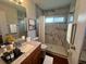 Modern bathroom featuring sleek fixtures, marble tile, and a glass-enclosed shower for a spa-like experience at 12139 Buffington Ln, Riverview, FL 33579