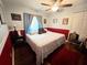Cozy bedroom with wood floors, ceiling fan, and comfortable furnishings at 12139 Buffington Ln, Riverview, FL 33579