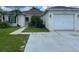 Single story home featuring a two car garage, covered entry and mature landscaping at 12139 Buffington Ln, Riverview, FL 33579