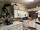 Functional kitchen with white cabinets, appliances, and ample counter space for cooking at 12139 Buffington Ln, Riverview, FL 33579
