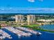 Aerial view of the two high-rise buildings, set on a waterfront with marina and lush greenery at 130 Riviera Dunes Way # 606, Palmetto, FL 34221