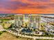 Stunning aerial view of waterfront condos with beautiful sunset and manicured lawns at 130 Riviera Dunes Way # 606, Palmetto, FL 34221