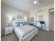 Bright bedroom featuring neutral walls, a ceiling fan, and a dedicated workspace for comfort and productivity at 130 Riviera Dunes Way # 606, Palmetto, FL 34221