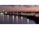 Nighttime view of a bridge with cars and lights reflected in the water, showcasing urban connectivity at 130 Riviera Dunes Way # 606, Palmetto, FL 34221