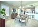 Charming dining area near the kitchen with a lovely chandelier and natural lighting at 130 Riviera Dunes Way # 606, Palmetto, FL 34221