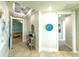 Inviting entryway with tray ceiling, tile floors, and unique decorative art at 130 Riviera Dunes Way # 606, Palmetto, FL 34221