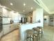 Well-lit kitchen with bar stool seating and sleek appliances near the entryway at 130 Riviera Dunes Way # 606, Palmetto, FL 34221