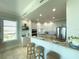 Modern kitchen with a breakfast bar, stainless appliances, and tile flooring at 130 Riviera Dunes Way # 606, Palmetto, FL 34221