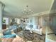 Open living room showcasing stylish decor, modern lighting, and seamless flow into dining area and kitchen at 130 Riviera Dunes Way # 606, Palmetto, FL 34221