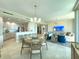 Open-concept living space featuring modern furnishings, dining area, and access to kitchen with stainless steel appliances at 130 Riviera Dunes Way # 606, Palmetto, FL 34221