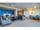 Contemporary lounge featuring modern sofas, a fireplace, and a dining area with blue accents at 130 Riviera Dunes Way # 606, Palmetto, FL 34221