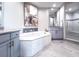 Luxurious main bathroom with soaking tub, double vanity, and walk-in shower, creating a spa-like retreat at 130 Riviera Dunes Way # 606, Palmetto, FL 34221