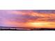 Stunning sunrise view with vibrant orange and pink hues reflecting off the water and sky at 130 Riviera Dunes Way # 606, Palmetto, FL 34221
