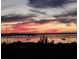 Scenic evening water view with boats passing and a colorful sunset enhancing the horizon at 130 Riviera Dunes Way # 606, Palmetto, FL 34221