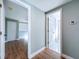 Hallway with access to bath and bedroom, featuring wood-look floors and modern finishes at 13304 Neptune Dr, Hudson, FL 34667