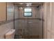 Bathroom featuring a large tiled shower with glass door and a stone bench seat at 13305 Whitby Rd, Hudson, FL 34667