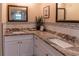 Bathroom featuring granite countertops, dual sinks, and a framed mirror and plant decor at 13305 Whitby Rd, Hudson, FL 34667