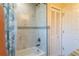 Bright bathroom featuring modern tiles, tub with shower, and natural light at 13305 Whitby Rd, Hudson, FL 34667