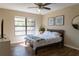 Bright bedroom with modern flooring, ceiling fan and natural light at 13305 Whitby Rd, Hudson, FL 34667