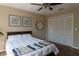 Comfortable bedroom with a king-size bed, closet, ceiling fan and modern decor at 13305 Whitby Rd, Hudson, FL 34667