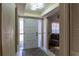Welcoming front door with decorative glass, sidelights, and tiled entryway, leading into a cozy living space at 13305 Whitby Rd, Hudson, FL 34667