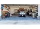 Well-organized garage space with custom shelves and storage, offering ample room for a car and tools at 13305 Whitby Rd, Hudson, FL 34667