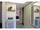 Hallway with decor, tile floors, and soft lighting, connecting different areas of a house at 13305 Whitby Rd, Hudson, FL 34667
