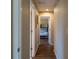 Hallway with modern flooring leads to a bedroom with bunk beds at 13305 Whitby Rd, Hudson, FL 34667