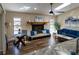 Comfortable living room with a fireplace, ample seating, and natural light streaming in, perfect for relaxing at 13305 Whitby Rd, Hudson, FL 34667